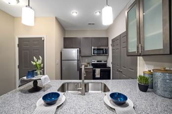 a kitchen with stainless steel appliances and granite counter tops